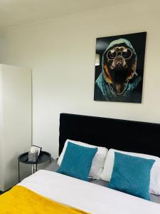 a bedroom with a bed with a picture of a dog at Lovely studio centrally located in Peterborough