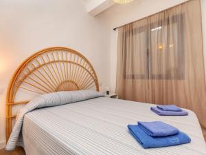 a bedroom with a large bed with two towels on it at Apartment Edificio Candela-1 by Interhome in L'Ametlla de Mar