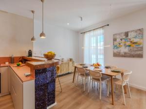 a kitchen and dining room with a table and chairs at Apartment Edificio Candela-1 by Interhome in L'Ametlla de Mar