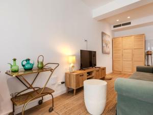 a living room with a tv and a couch at Apartment Edificio Candela-1 by Interhome in L'Ametlla de Mar