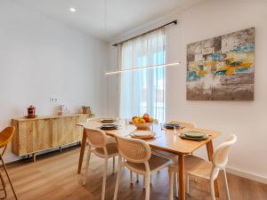 a kitchen and dining room with a wooden table and chairs at Apartment Edificio Candela-1 by Interhome in L'Ametlla de Mar +20 photos