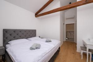 a bedroom with a white bed with two towels on it at Villa Sofija in Vodnjan +48 photos