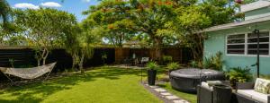 a backyard with a hammock and a hot tub at Cozy RV tiny home in Fort Lauderdale +3 photos
