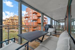 a balcony with a table and chairs and a building at Modern Apartment in Ski in Siggerud