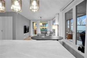 a white living room with a table and a couch at Modern Apartment in Ski in Siggerud