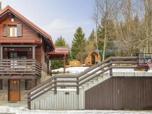 a wooden house with a wooden gate and a fence at Chalet Cozy Bear Cabin by Interhome in Mrkopalj