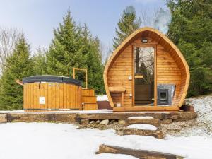 a wooden cabin with a door in the snow at Chalet Cozy Bear Cabin by Interhome in Mrkopalj