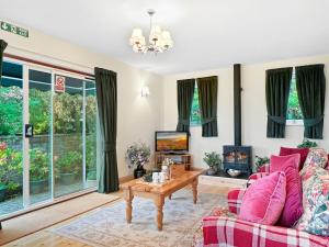 a living room with a couch and a tv at Exmoor View Wootton Courtenay in Minehead