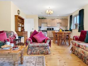 a living room with two couches and a table at Exmoor View Wootton Courtenay in Minehead +9 photos