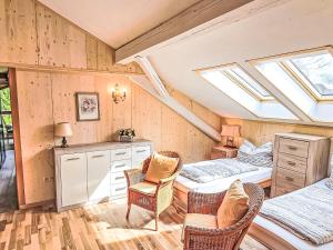a bedroom with a bed and a desk and chairs at Apartment Apt- Luna by Interhome in Feldkirchen in Kärnten