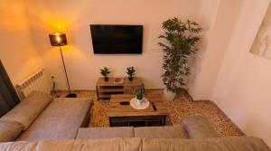 a living room with a couch and a tv at Ruralux Sierra Castril in Huéscar