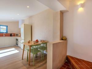 a kitchen and dining room with a table and chairs at Apartment Edificio Candela-2 by Interhome in L'Ametlla de Mar