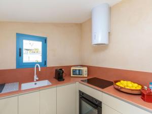 a kitchen with a sink and a bowl of fruit on the counter at Apartment Edificio Candela-2 by Interhome in L'Ametlla de Mar