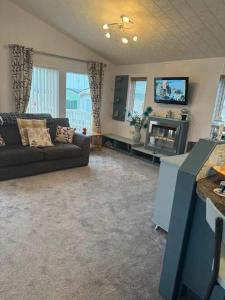 a living room with a couch and a tv at Jude 615 in Barmouth