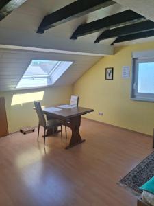 a room with a table and a chair and a window at Haus Tanja in Neckarbischofsheim