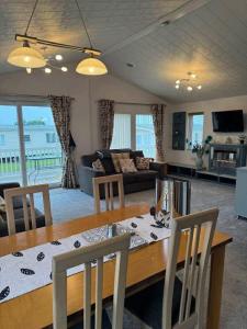 a dining room and living room with a table and chairs at Jude 615 in Barmouth