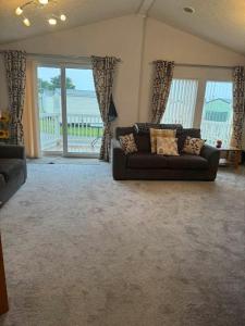 a living room with a couch and a large window at Jude 615 in Barmouth