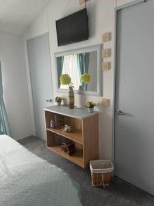a bedroom with a bed and a television on a wall at Jude 615 in Barmouth