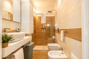 a bathroom with a sink and a toilet and a shower at AMBRA - Casa Vista Mare in San Teodoro +9 photos