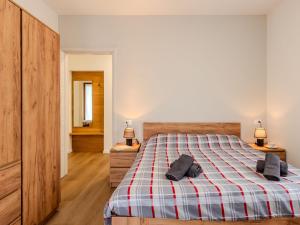 a bedroom with a bed with a plaid blanket at Holiday Home Mimi by Interhome in Verceia