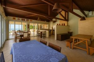 a dining room with a blue table and chairs at Mansão Ouro Verde Beira Mar in Piçarras