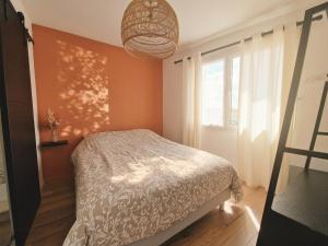 a bedroom with a bed and a large window at Liv'in Saint Seb, proche de Nantes in Saint-Sébastien-sur-Loire