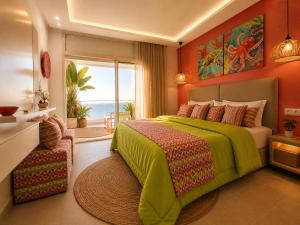 a bedroom with a green bed with a view of the ocean at Maison Bella View in Moulay Bousselham