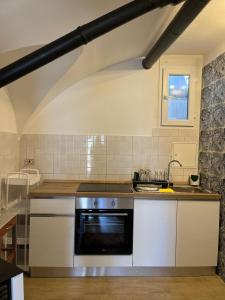 a kitchen with a sink and a stove at Lûc Dal Aur in Sùtrio +1 photo