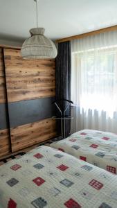 a bedroom with a bed and a wooden wall at Appartement Wurm- nahe Hochzillertal für Familien in Kaltenbach +24 photos