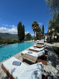 a pool with chaise lounge chairs and a swimming pool at Escondida in Nice
