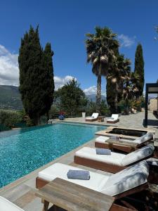 a swimming pool with chaise lounge chairs and a resort at Escondida in Nice