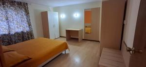 a small room with a bed and a small bedroom at Hotel Paolino in Cavareno +3 photos