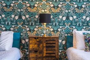 a bedroom with a bed and a lamp on a table at 3BR Pontypool Haven - Sleeps 6 with Parking in Pontnewynydd