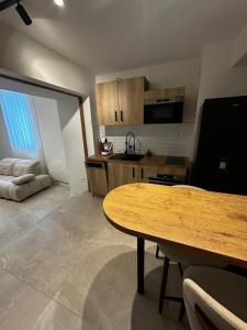 a kitchen with a wooden table in a room at Hyper centre ville de Reims avec parking in Reims
