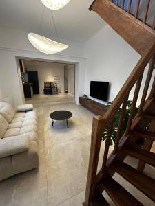a living room with a couch and a table at Hyper centre ville de Reims avec parking in Reims
