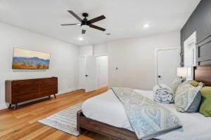 a bedroom with a bed and a ceiling fan at Munice at Trinity Grove in Dallas