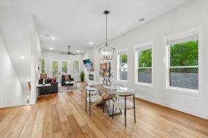 a dining room and living room with a table and chairs at Munice at Trinity Grove in Dallas