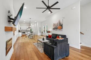 a living room with a couch and a ceiling fan at Munice at Trinity Grove in Dallas