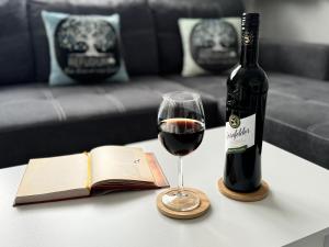 a bottle of wine and a glass on a table at Refugium 2020 in Marienheide +39 photos
