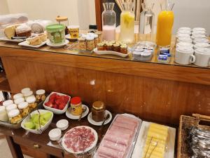 a buffet with different types of food on a table at Hotel Piero in Villa Mercedes +5 photos
