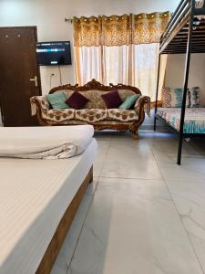 a living room with two beds and a couch at The Plum in Mukteshwar