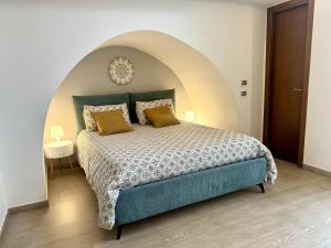 a bedroom with a large bed with an arched ceiling at I quattro Pumi in Mola di Bari +17 photos
