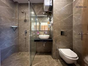 a bathroom with a shower and a sink and a toilet at The Stone Age : a boutique hotel in Shimla +41 photos