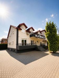 a building with a sign that reads ville whisper at VilaMihaela in Skopje