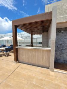 a building with a patio with a roof at Smart Pituba Studio Premium in Salvador
