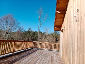 a wooden deck on a house with a tree on it at maison wave in Léon +7 photos