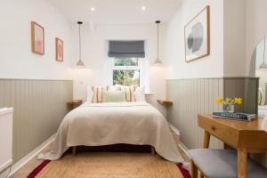 a bedroom with a bed and a desk at Border View Cottage in Duddo