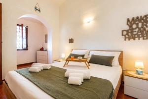 a bedroom with a large bed with a table on it at ALBA - Seaview Luxury in San Teodoro +10 photos
