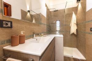a bathroom with a white sink and a mirror at ALBA - Seaview Luxury in San Teodoro
