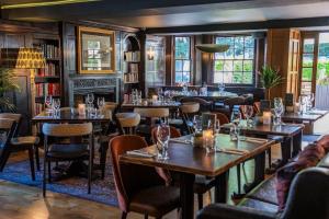 a restaurant with tables and chairs and a fireplace at The Royal Foresters, Ascot, Berkshire - Acorn Pubs in Ascot +34 photos